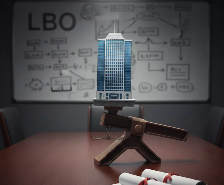 LBO marqué sur un tableau flou avec une entreprise en levier